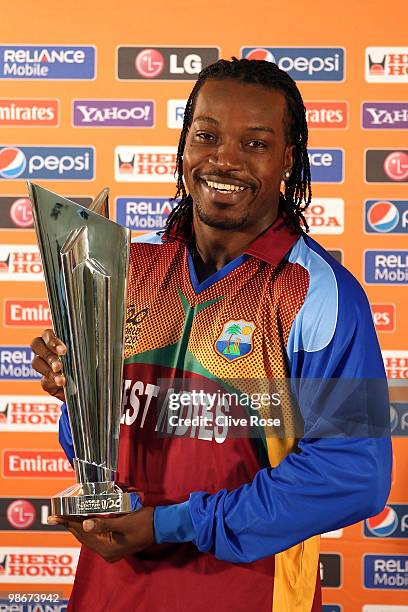 Chris Gayle of West Indies poses with the winners trophy during a press conference ahead of the ICC T20 World Cup at the Pegasus Hotel on April 26,...