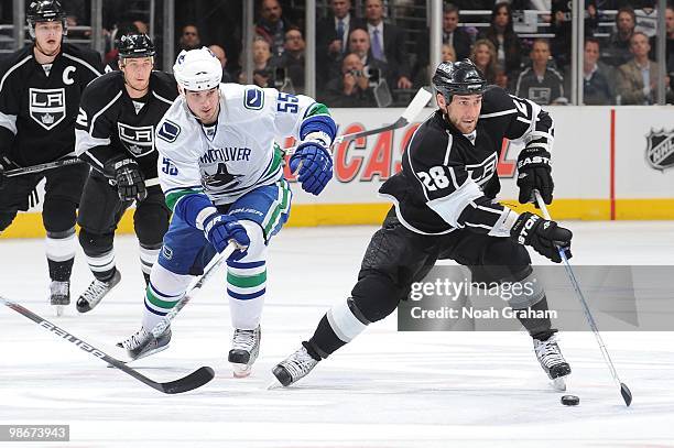 Jarret Stoll of the Los Angeles Kings skates with the puck against Shane O'Brien of the Vancouver Canucks in Game Four of the Western Conference...