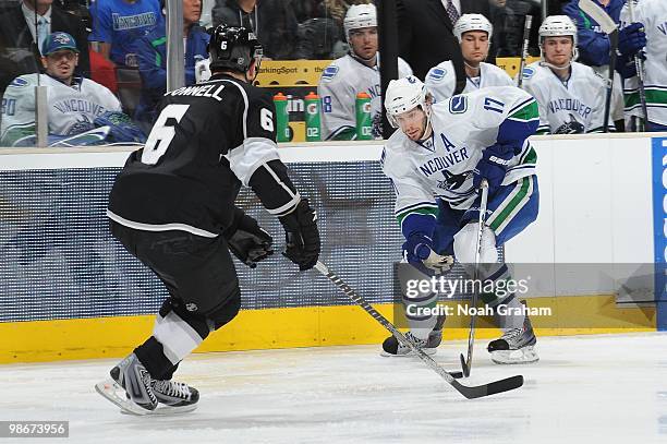 Ryan Kesler of the Vancouver Canucks skates with the puck against Sean O'Donnell of the Los Angeles Kings in Game Four of the Western Conference...