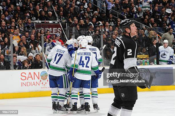 Ryan Kesler, Kyle Wellwood and Steve Bernier of the Vancouver Canucks celebrate after a goal against Matt Greene of the Los Angeles Kings in Game...