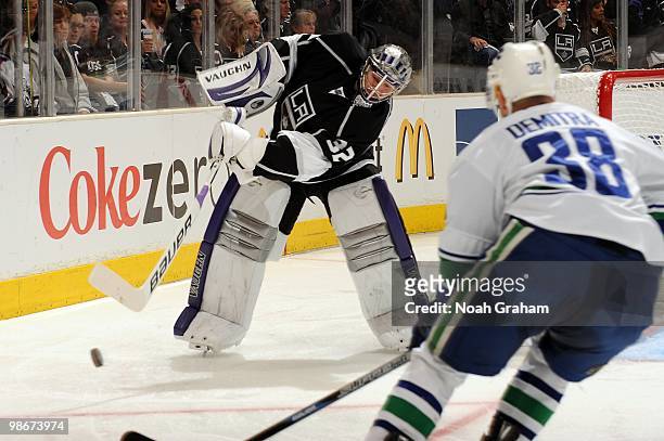 Jonathan Quick of the Los Angeles Kings clears the puck against Pavol Demitra of the Vancouver Canucks in Game Four of the Western Conference...