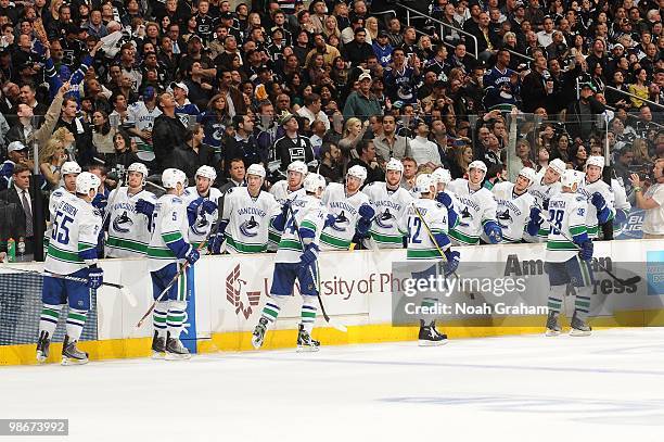 Shane O'Brien, Christian Ehrhoff, Alexandre Burrows, Kyle Wellwood and Pavol Demitra of the Vancouver Canucks celebrate with the bench after a goal...