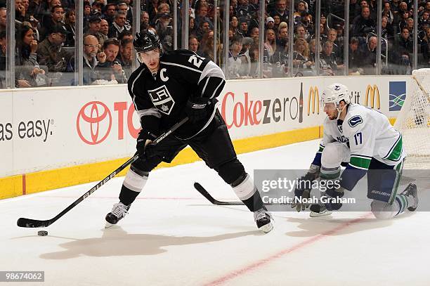 Dustin Brown of the Los Angeles Kings skates with the puck against Ryan Kesler of the Vancouver Canucks in Game Four of the Western Conference...