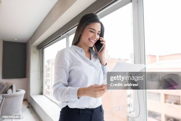 happy business woman talking on the phone - person looking at phone while smiling australia stock pictures, royalty-free photos & images