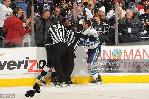 Wayne Simmonds of the Los Angeles Kings is pulled away from Kevin Bieksa of the Vancouver Canucks in Game Four of the Western Conference...