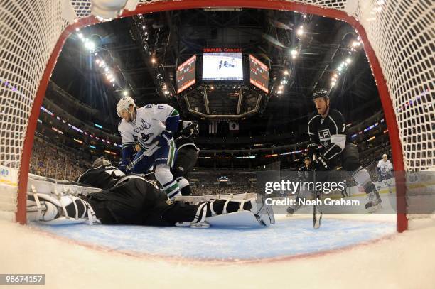 Ryan Kesler of the Vancouver Canucks skates with the puck against Jonathan Quick and Rob Scuderi of the Los Angeles Kings in Game Four of the Western...