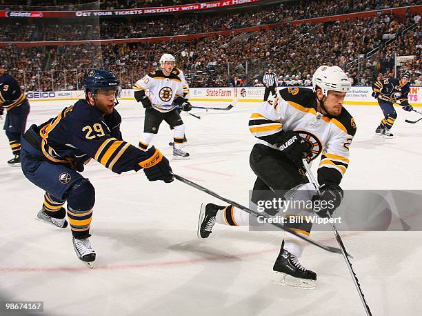 Jason Pominville of the Buffalo Sabres reaches for Andrew Ference of the Boston Bruins in Game Five of the Eastern Conference Quarterfinals during...