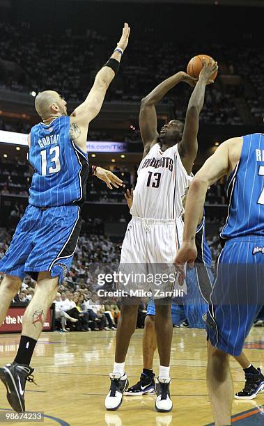Center Nazr Mohammed of the Charlotte Bobcats shoots over center Marcin Gortat of the Orlando Magic during Game Three of the Eastern Conference...