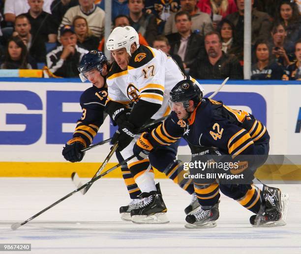 Nathan Gerbe and Tim Kennedy of the Buffalo Sabres skate alongside Milan Lucic of the Boston Bruins in Game Five of the Eastern Conference...