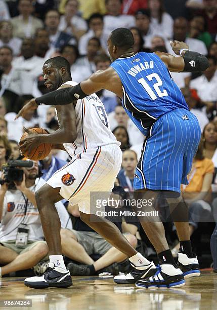 Center Dwight Howard of the Orlando Magic defends center Nazr Mohammed of the Charlotte Bobcats during Game Three of the Eastern Conference...