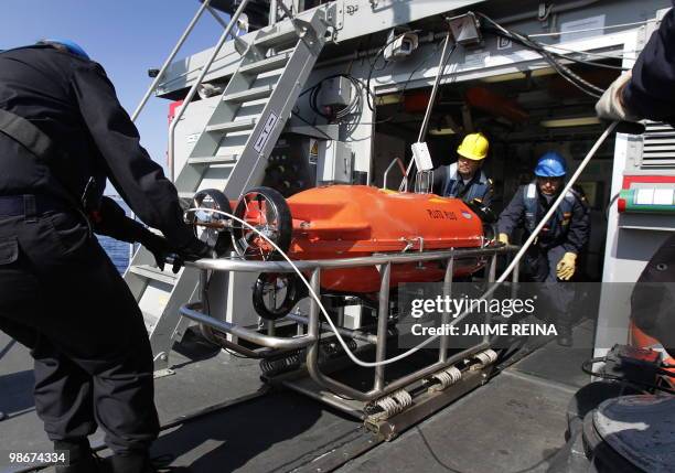 The crew of the SPS Tajo minehunter ship carries the remotely operated vehicle "Pluto Plus" during NATO naval exercises "Minex-10" off the coast of...