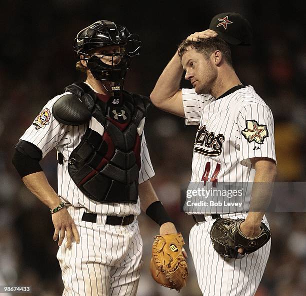 Pitcher Roy Oswalt of the Houston Texans holds his head as he talks to catcher J.R. Towles after giving up two home runs in the seventh inning...