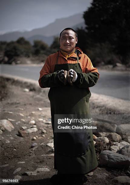 Tibetan pilgrim Xiama Yixi poses for a photo during his pilgrimage trip along a road at the Bayi Township on April 26, 2010 in Nyingchi County of...