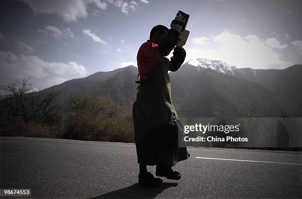 Tibetan pilgrim prays during his pilgrimage trip along a road at the Bayi Township on April 26, 2010 in Nyingchi County of Tibet Autonomous Region,...