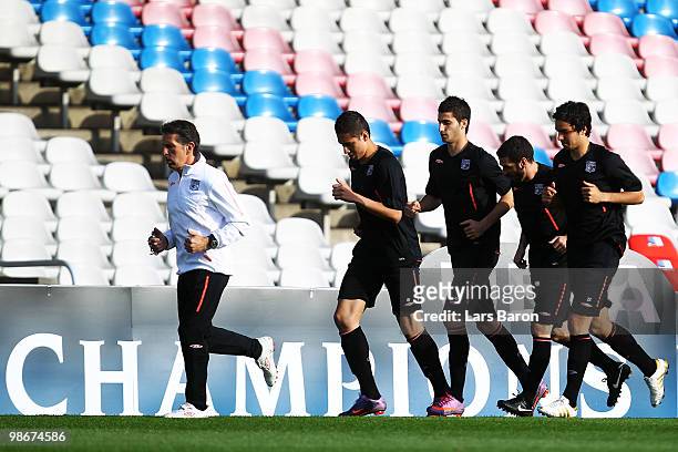 Head coach Claude Puel warms up with his players during a Olympic Lyon training session at Stade de Gerland on April 26, 2010 in Lyon, France. Lyon...