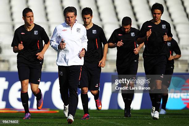 Head coach Claude Puel warms up with his players during a Olympic Lyon training session at Stade de Gerland on April 26, 2010 in Lyon, France. Lyon...