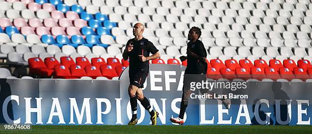 Cris warms up with team mate Jean Makoun during a Olympic Lyon training session at Stade de Gerland on April 26, 2010 in Lyon, France. Lyon will play...