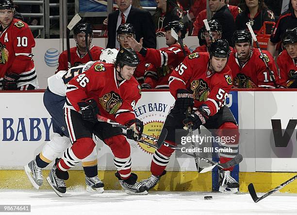Ben Eager and Colin Fraser of the Chicago Blackhawks chase after the puck at Game Two of the Western Conference Quarterfinals against the Nashville...