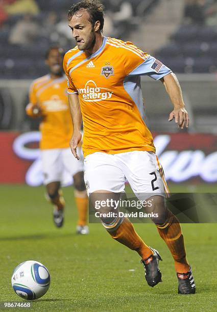 Eddie Robinson of the Houston Dynamo moves the ball forward against the Chicago Fire in an MLS match on April 24, 2010 at Toyota Park in Brideview,...