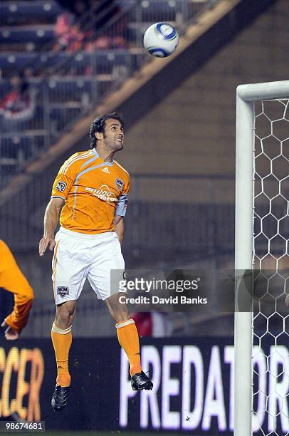 Brian Mullan of the Houston Dynamo heads the ball forward against the Chicago Fire in an MLS match on April 24, 2010 at Toyota Park in Brideview,...