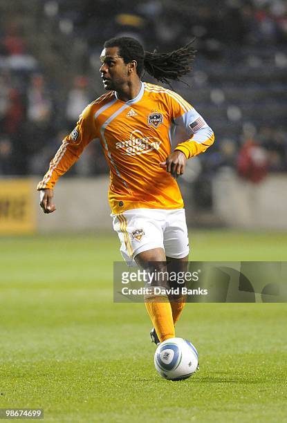 Adrian Serioux of the Houston Dynamo moves the ball forward against the Chicago Fire in an MLS match on April 24, 2010 at Toyota Park in Brideview,...