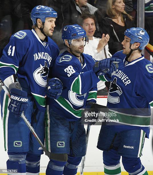 Pavol Demitra of the Vancouver Canucks is congratulated by teammates Kyle Wellwood and Andrew Alberts after scoring in Game Five of the Western...