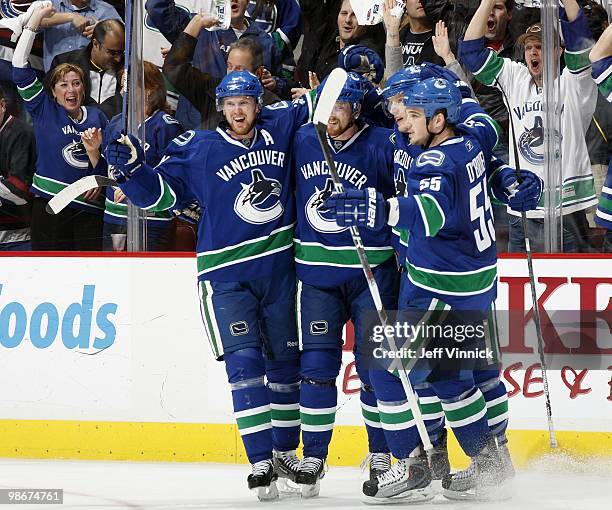 Henrik Sedin, Daniel Sedin, Christian Ehrhoff and Shane O'Brien of the Vancouver Canucks celebrate a goal in Game Five of the Western Conference...