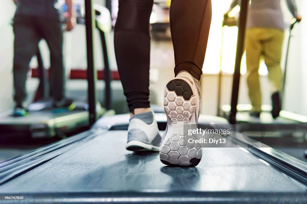 Exercise treadmill cardio running workout at fitness gym of woman taking weight loss with machine aerobic for slim and firm healthy in the morning. concept of running and sports. running athletes