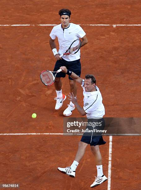 Roger Federer and Yves Allegro of Switzerland in action against Johan Brunstrom of Sweden and Jean-Julien Rojer of Netherlands Antilles during day...