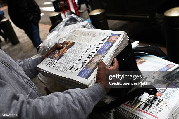 Vendor holds an issue of The Wall Street Journal on April 26, 2010 in New York City. The Wall Street Journal commenced a New York edition today that...