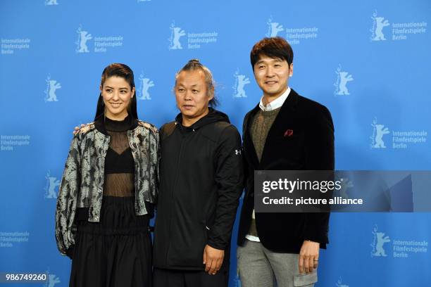 February 2018, Germany, Berlin: Berlinale 2018, photocall, 'Human, Space, Time and Human' : Actress Mina Fujii , director Kim Ki-duk and actor Lee...