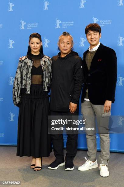 February 2018, Germany, Berlin: Berlinale 2018, photocall, 'Human, Space, Time and Human' : Actress Mina Fujii , director Kim Ki-duk and actor Lee...