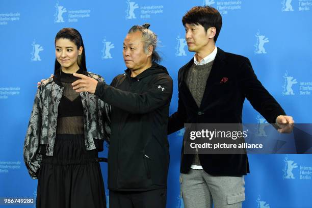 February 2018, Germany, Berlin: Berlinale 2018, photocall, 'Human, Space, Time and Human' : Actress Mina Fujii , director Kim Ki-duk and actor Lee...