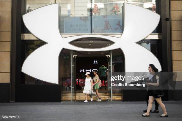 Pedestrians and shoppers walk past an Under Armour Inc. Store on Wangfujing Street in Beijing, China, on Wednesday, June 27, 2018. Consumer sentiment...