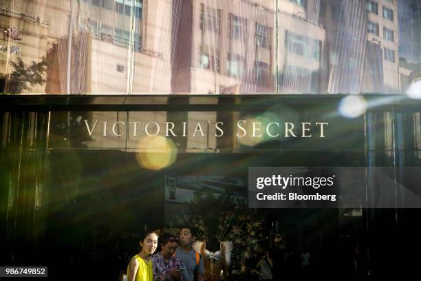 Pedestrians walk past a Victoria's Secret Stores LLC store on Wangfujing Street in Beijing, China, on Wednesday, June 27, 2018. Consumer sentiment in...