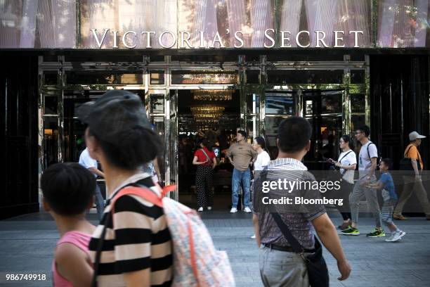 Pedestrian walk past a Victoria's Secret Stores LLC store on Wangfujing Street in Beijing, China, on Wednesday, June 27, 2018. Consumer sentiment in...