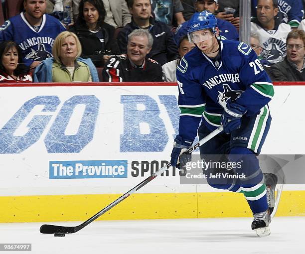 Mikael Samuelsson of the Vancouver Canucks skates up ice with the puck in Game Five of the Western Conference Quarterfinals in their game against the...
