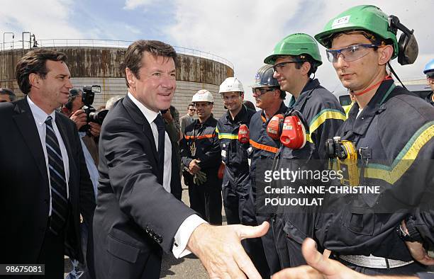 French Industry Minister Christian Estrosi and local MP Renaud Muselier salute workerd as they visit British group Ineos mediterranean refinery of...