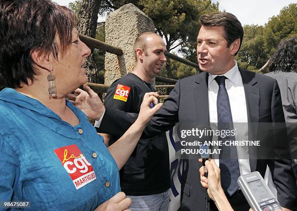 French Industry Minister Christian Estrosi speaks with a union representative as he visits British group Ineos mediterranean refinery of Lavera in...