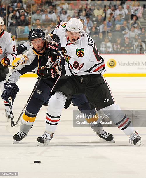 Dan Hamhuis of the Nashville Predators skates against Tomas Kopecky of the Chicago Blackhawks in Game Four of the Western Conference Quarterfinals...