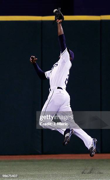 Outfielder B.J. Upton of the Tampa Bay Rays just misses a fly ball against the Toronto Blue Jays during the game at Tropicana Field on April 23, 2010...