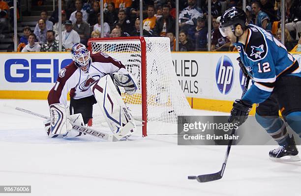 Patrick Marleau of the San Jose Sharks looks for a shot against goalie Peter Budaj of the Colorado Avalanche in Game Five of their Western Conference...