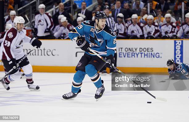 Ryane Clowe of the San Jose Sharks takes the puck to the goal for an assist against the Colorado Avalanche in Game Five of their Western Conference...