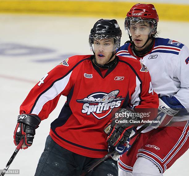 Taylor Hall of the Windsor Spitfires is held in check by Jonathan Jasper of the Kitchener Rangers in the 5th game of the Western Conference Final on...