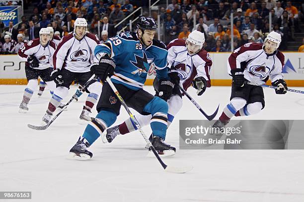 Ryane Clowe of the San Jose Sharks gets past Kyle Cumiskey of the Colorado Avalanche to set up a goal with an assist in the third period of Game Five...