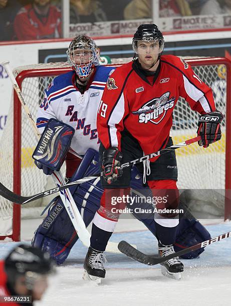 Zack Kassian of the Windsor Spitfires waits to tip a shot in front of Brandon Maxwell of the Kitchener Rangers in the 5th game of the Western...