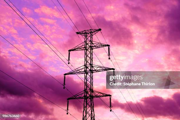 power line and sunset / ligne haute tension et coucher - haute voltige stock pictures, royalty-free photos & images