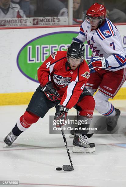 Taylor Hall of the Windsor Spitfires tries to control the puck in the 5th game of the Western Conference Final against the Kitchener Rangers on April...