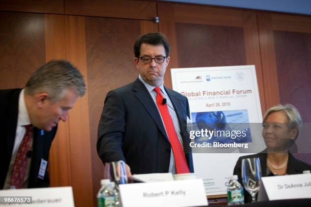 Robert Kelly, chief executive officer of Bank of New York Mellon Corp., center, takes his seat for a panel discussion with Duncan Niederauer, chief...