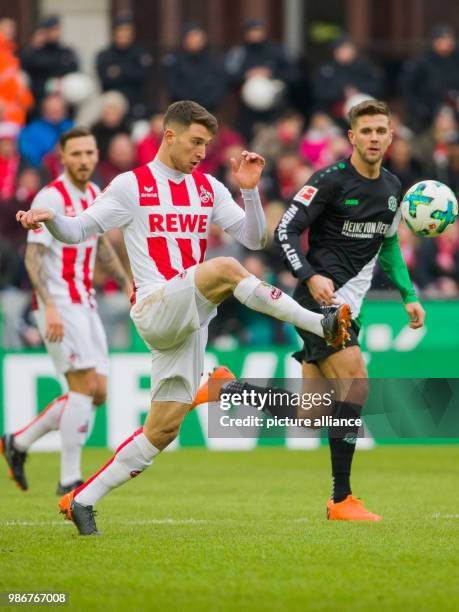 Hanover's Niclas Fuellkrug and Cologne's Salih Ozcan vie for the ball during the German Bundesliga soccer match between 1. FC Cologne and Hanover 96...